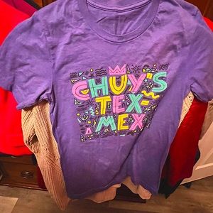 Chuy’s t shirt in new condition. The color is a like a heather purple. So comfy!